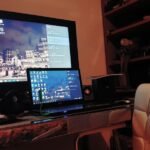 Modern gaming setup with laptop and monitor displaying browser games interface