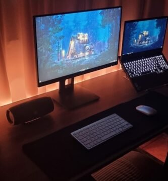 Modern dual-screen gaming setup for cross-platform survival games. Photo by Unsplash contributor.