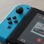 Nintendo Switch console showing game icons on screen, perfect for illustrating free Nintendo Switch games guide. Photo by Unsplash photographer.