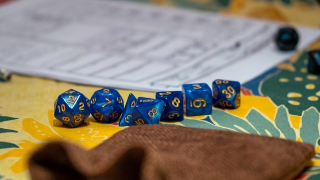 Fantasy RPG dice with numbers and character sheet on gaming table