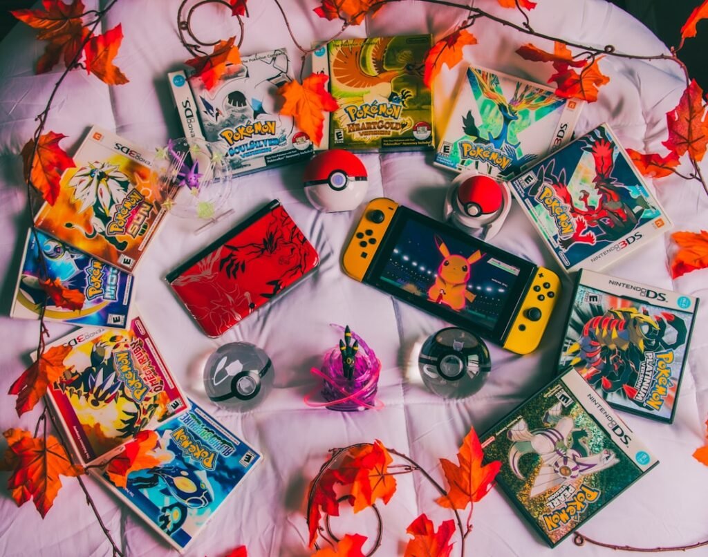 Nintendo Switch console surrounded by colorful game cartridges and autumn leaves, showcasing a diverse gaming collection. Photo by Alex Guillory.