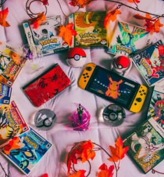 Nintendo Switch console surrounded by colorful game cartridges and autumn leaves, showcasing a diverse gaming collection. Photo by Alex Guillory.