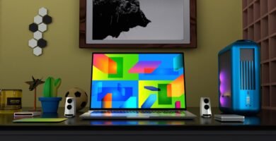 Colorful gaming setup desk with monitor displaying game library interface and RGB lighting - Photo by Alexander Andrews