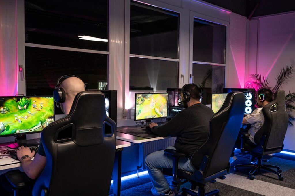 Professional esports gaming setup with multiple players at computer stations during competitive tournament
