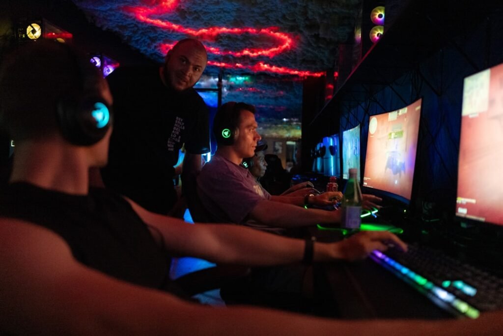 Competitive multiplayer gaming setup with multiple players at computers in gaming environment