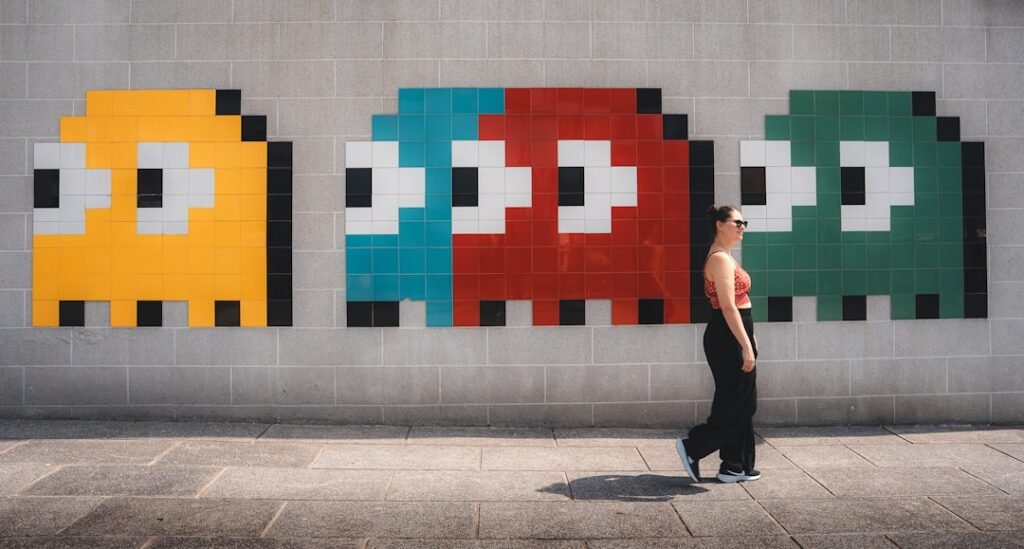 Colorful pixel art wall mural featuring classic arcade game ghost characters